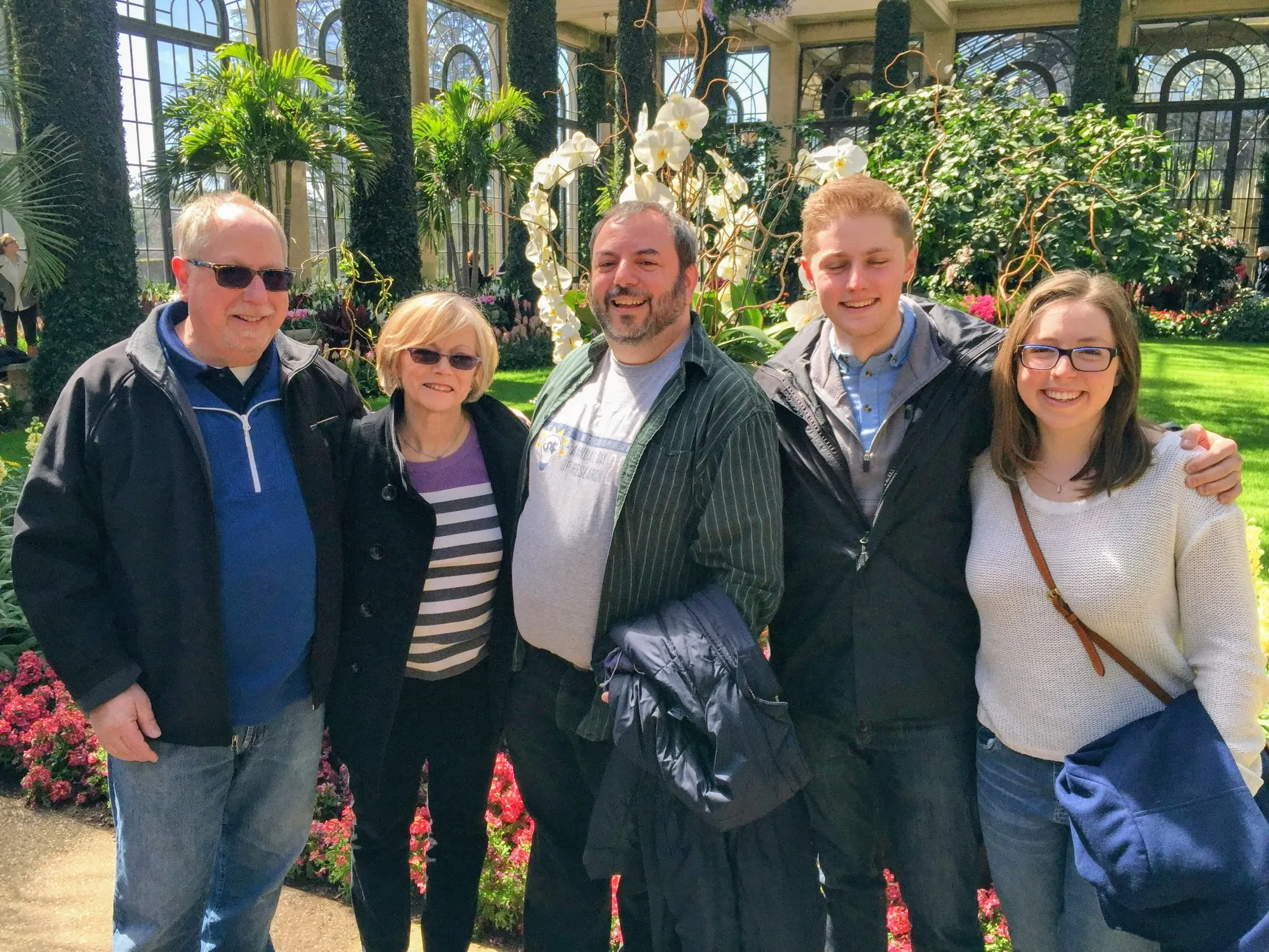The whole family together in a garden conservatory